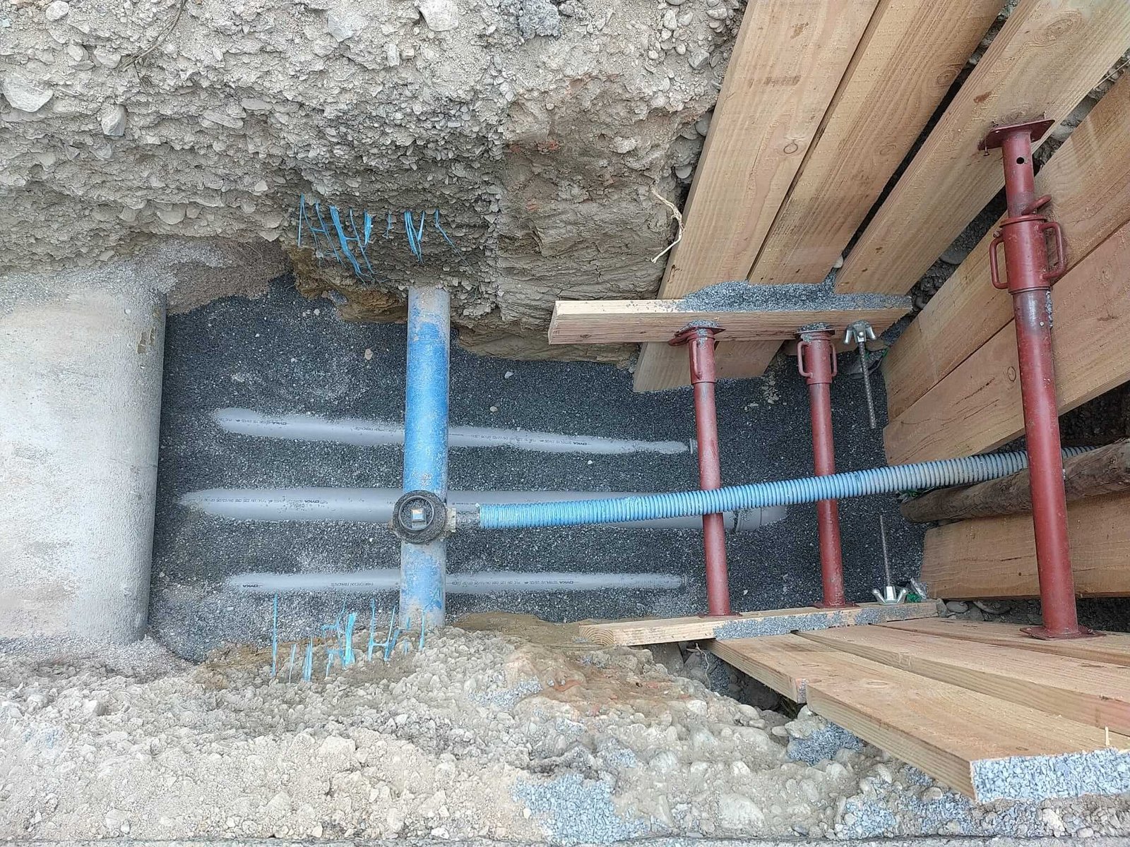 Installation d'un boisage dans une tranchée de 2 mètres de profondeur pour le raccordement au tout à l'égout de 3 maisons