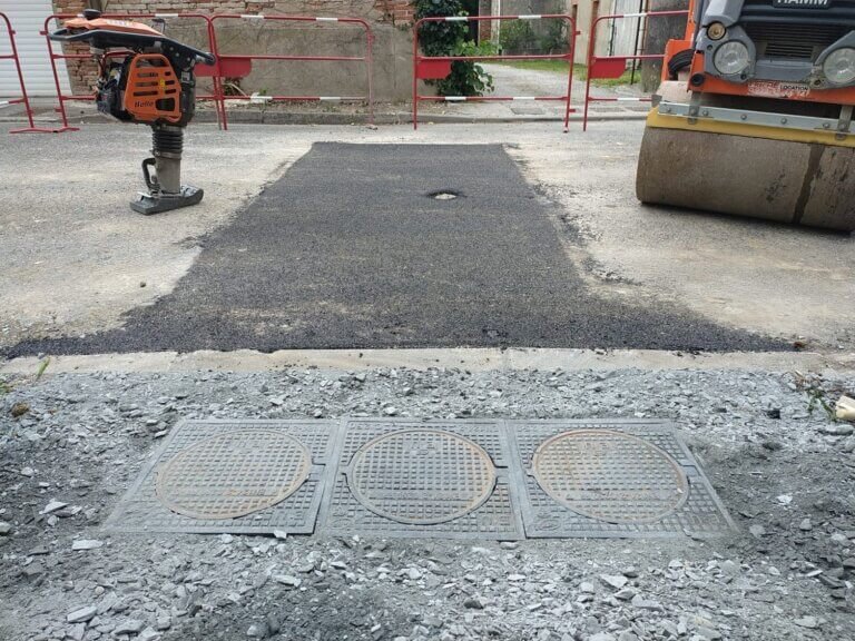 Remise en état de l'enrobé après avoi rebouché la tranchée et empierrement du trottoir